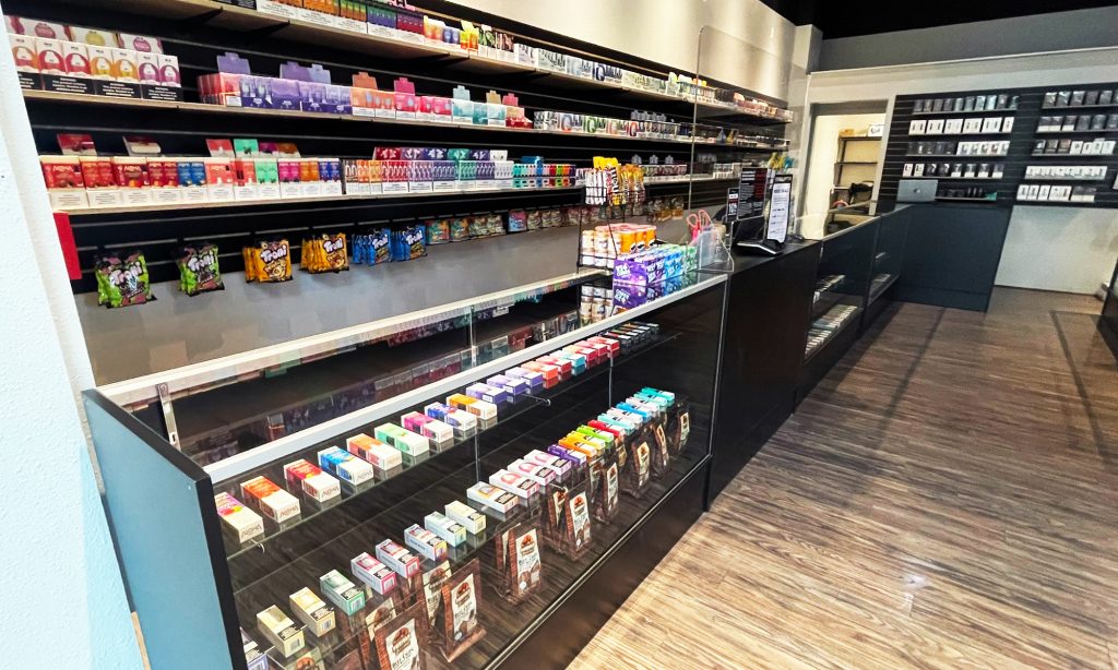 Showcases and slat wall shelves with perfectly merchandised products in a vape shop