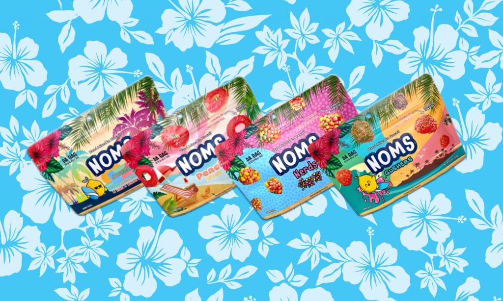 Assorted Noms candy from Hawaii Candy Factory with a white and blue Hawaiian-themed floral background