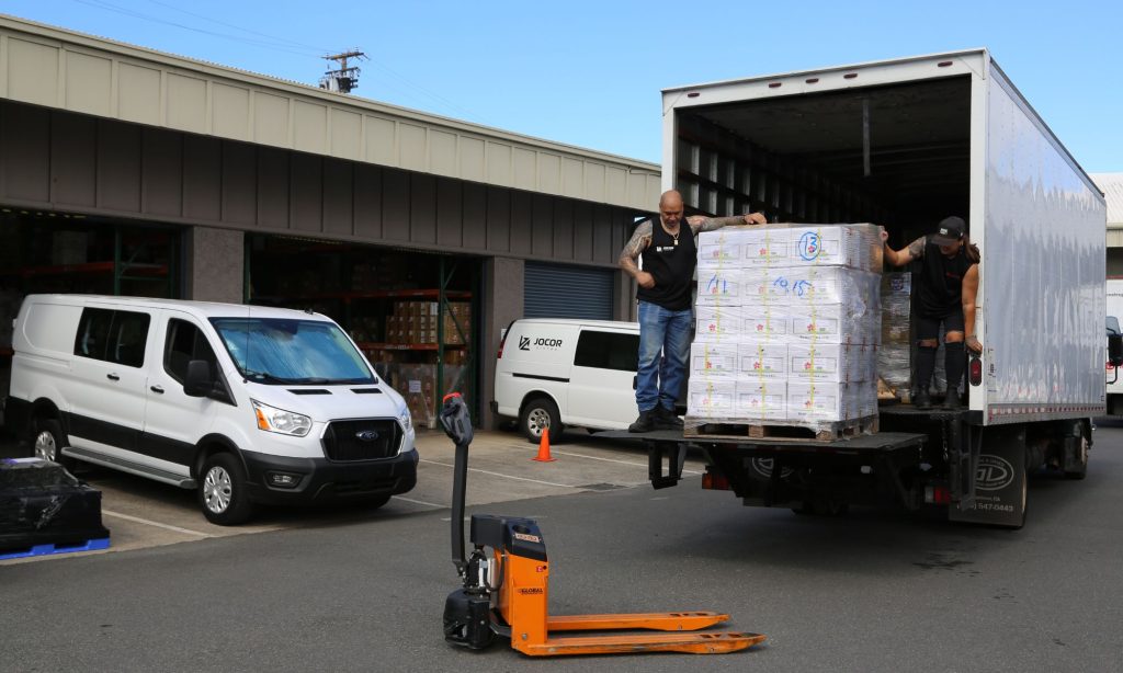 man unloading truck at a distribution warehouse